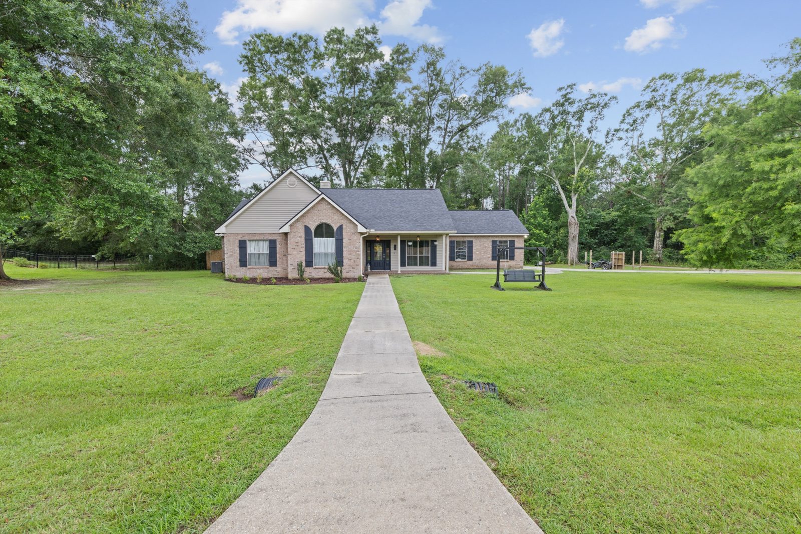Distant view of a ranch home across a wide lawn