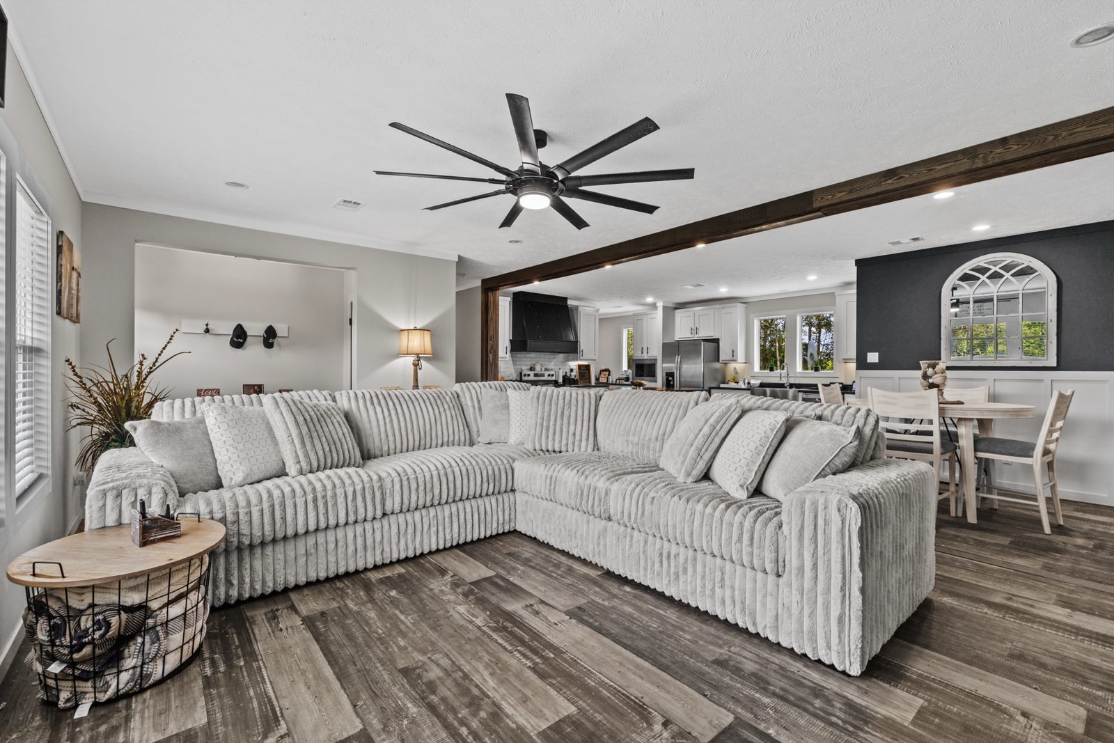Styled living room with sectional sofa and wood beam