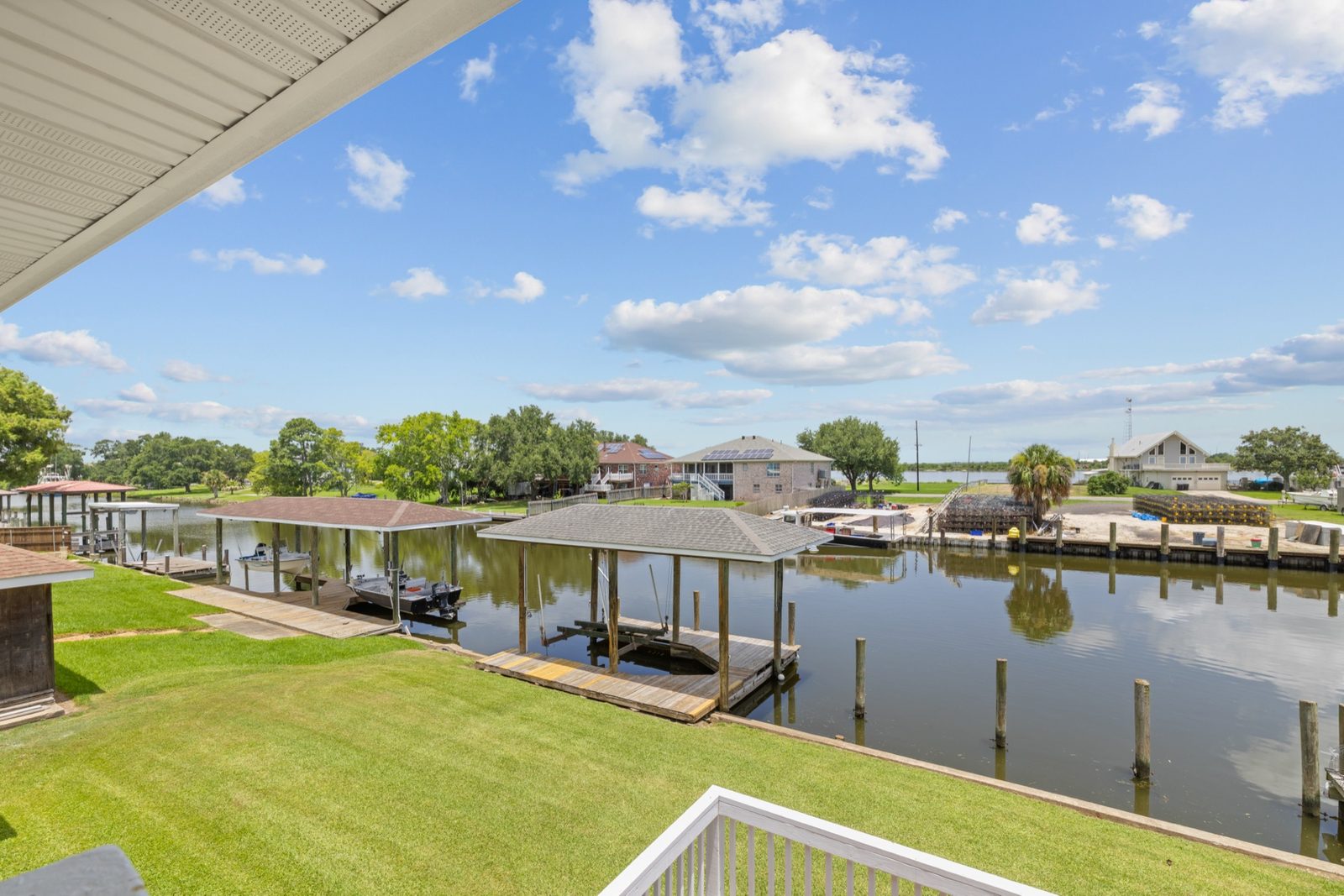 Elevated view over a canal with boathouse, docks and open sky